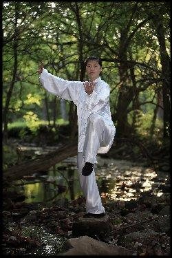 Chen Huixian performing an outdoor balance posture in an archival SCANews image